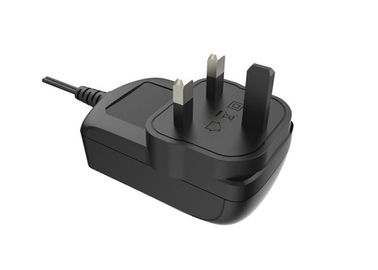 Un buen precio. Adaptador BRITÁNICO negro 12V 2A del soporte de la pared del enchufe con aprobaciones del EMC del CE en línea